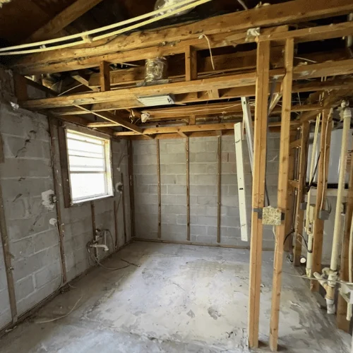 Dated kitchen in a Ruskin home after demolition — stripped to studs and slab